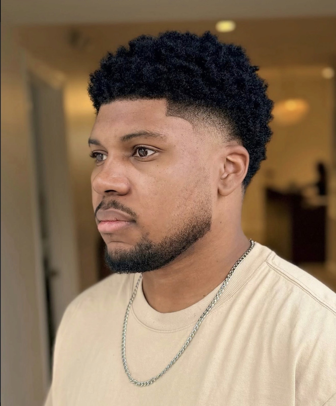 High Taper Fade.  Thick coarse curly hair.  Black male.  Barber. Beverly Hills. Bomane Salon. Courtney Palmore. Luxury Barber. Hairstylist. Sharp Line Up