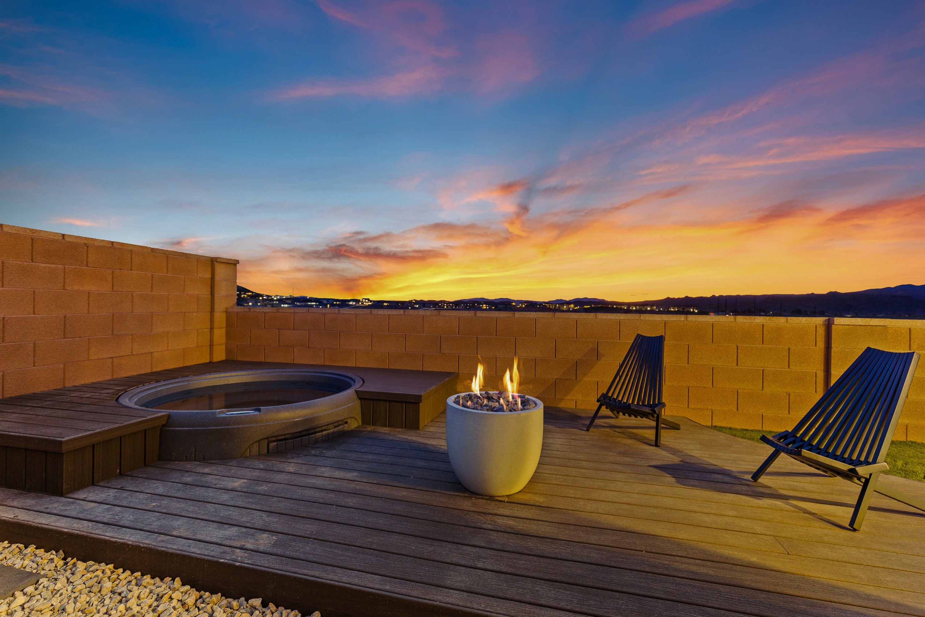 Backyard hot tub at The Painted Horizon in Hurricane, Utah set into a raised deck designed for outdoor relaxation.