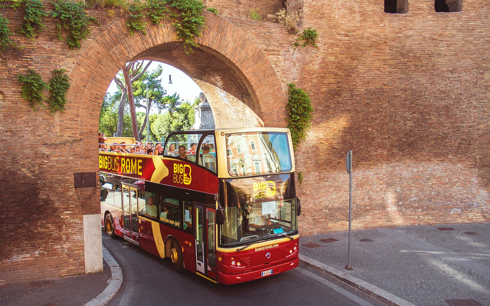 Rome sightseeing bus with tourists on Big Bus 24/48/72-Hr Hop-On Hop-Off Tour near Colosseum.