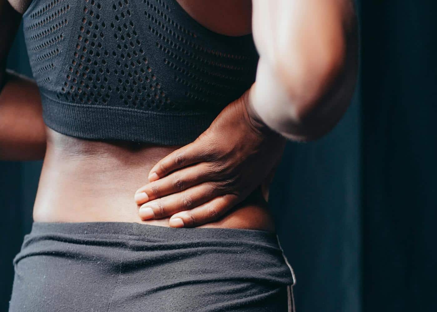 Posture reminder devices: Woman holding the small of her back