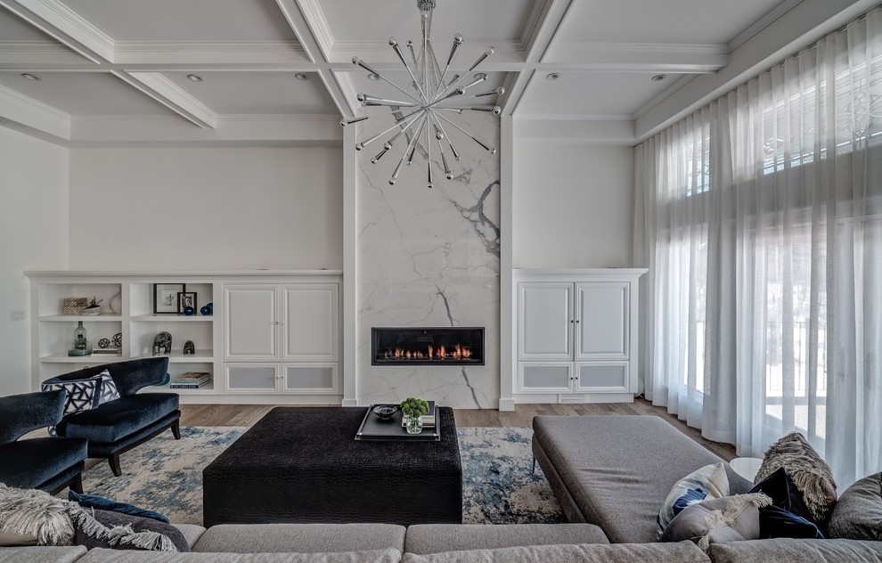 Image of Luxury living room with marble fireplace, modern furniture, and interior design by KHD Homes.