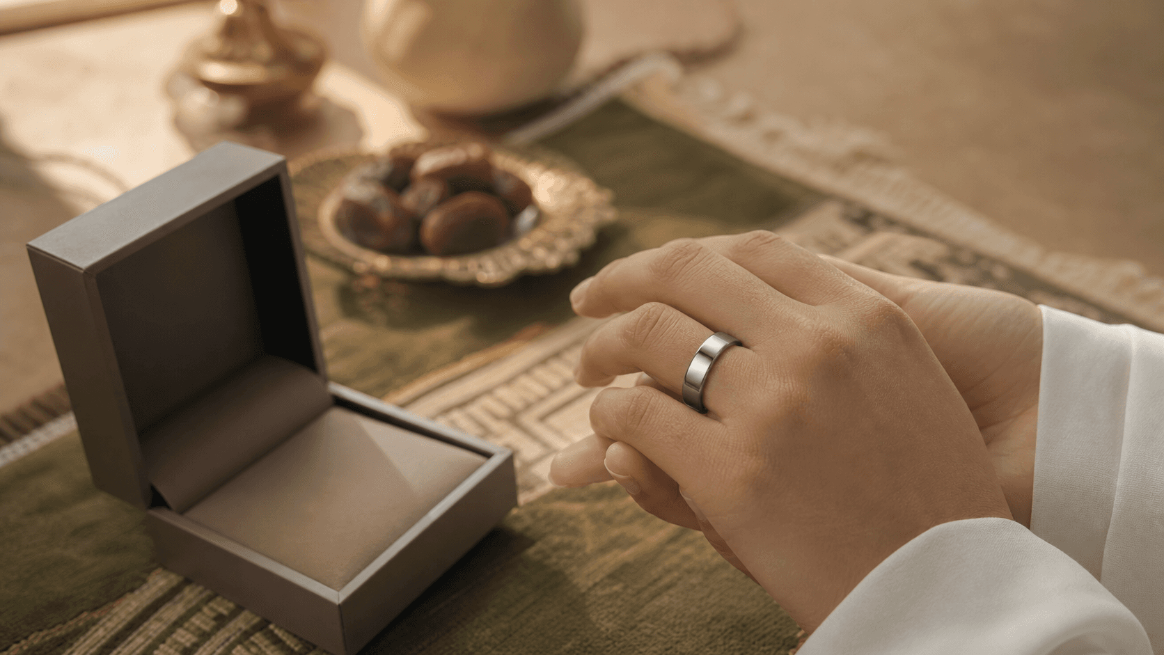 A plain Smart Dhikr Ring worn on the hand beside a gift box, the safest Islamic present when you are unsure