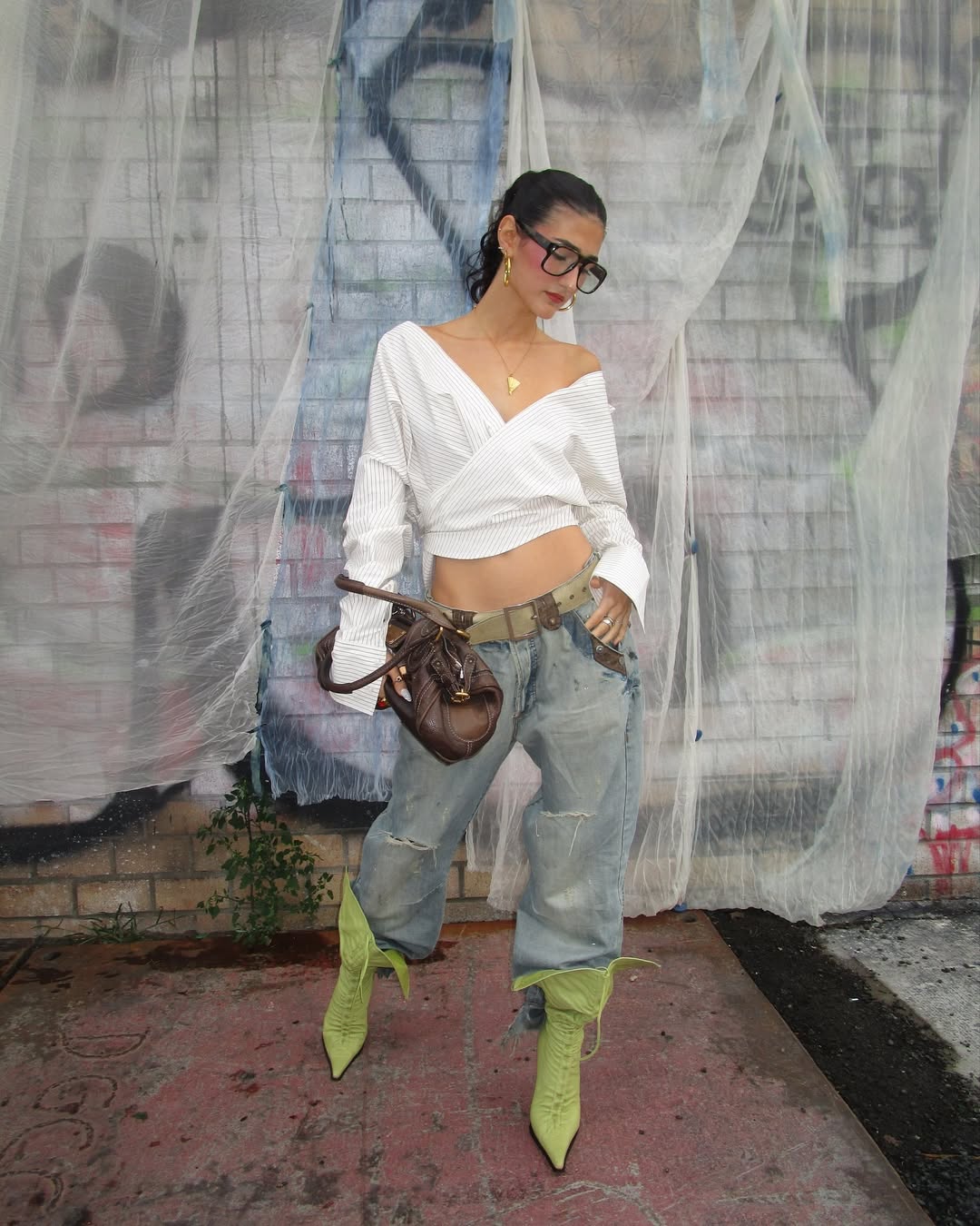 Instagram creator Pragya Beriwala in denim and a blue bow sitting on the sofa