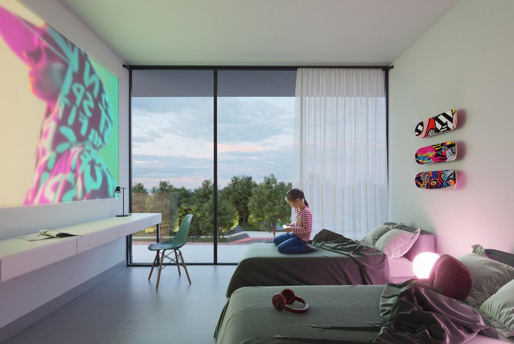 A stylish bedroom showcasing a large window that overlooks the city, part of The Gate 5.