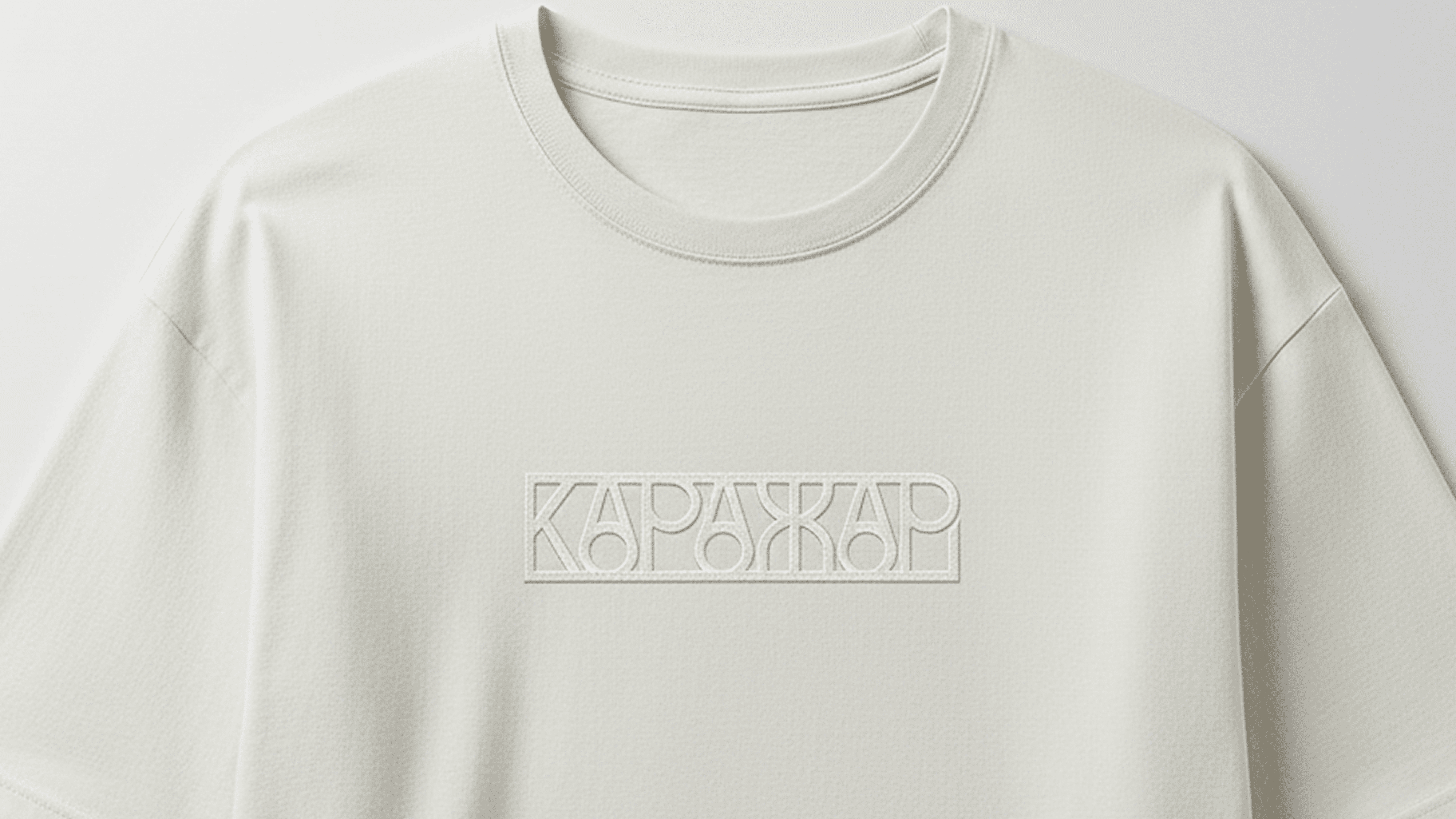 A close-up of a plain white t-shirt, featuring a round neckline and short sleeves.