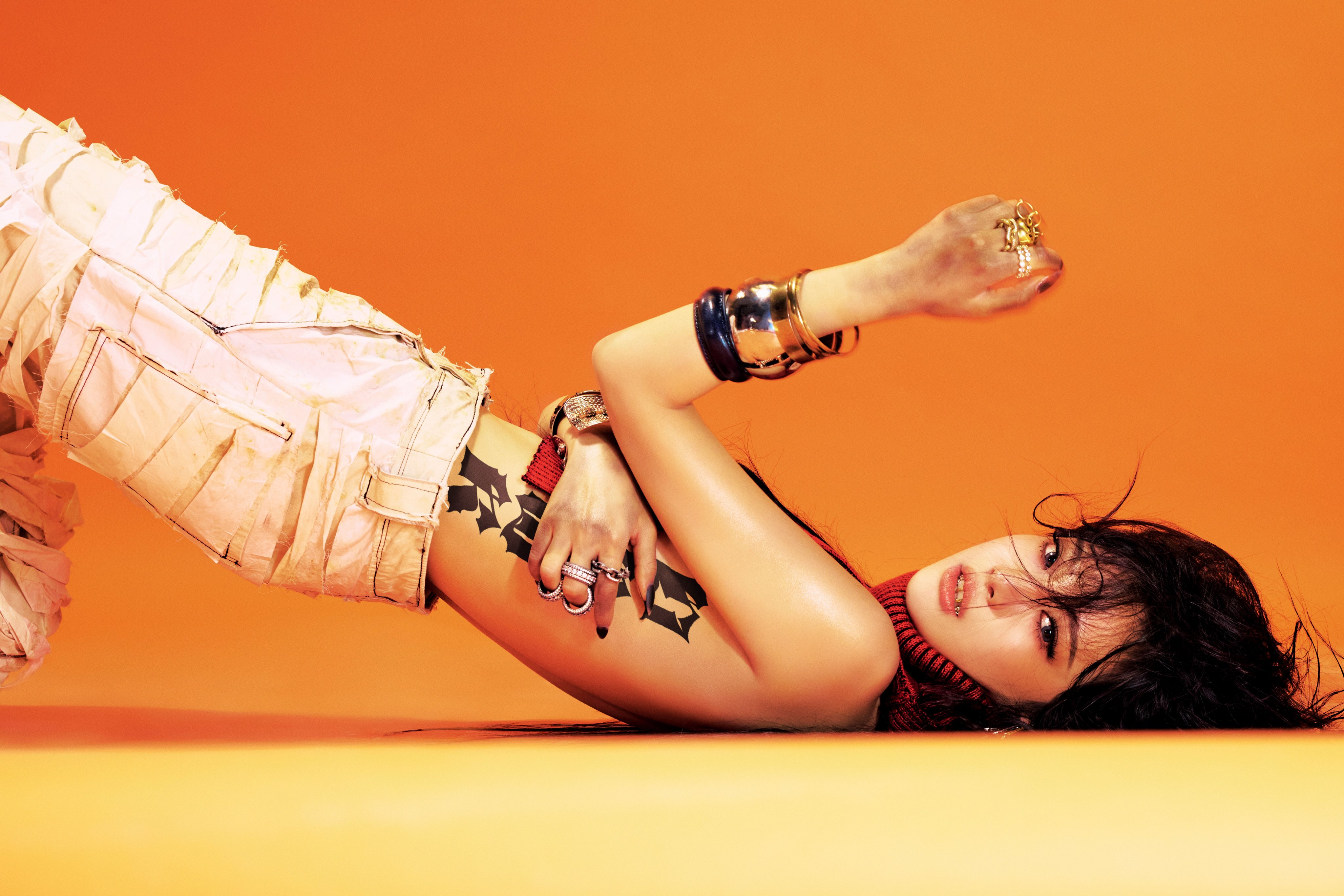 Ningning of aespa lying down on the ground in a concept photo for the group's single "Dirty Work".