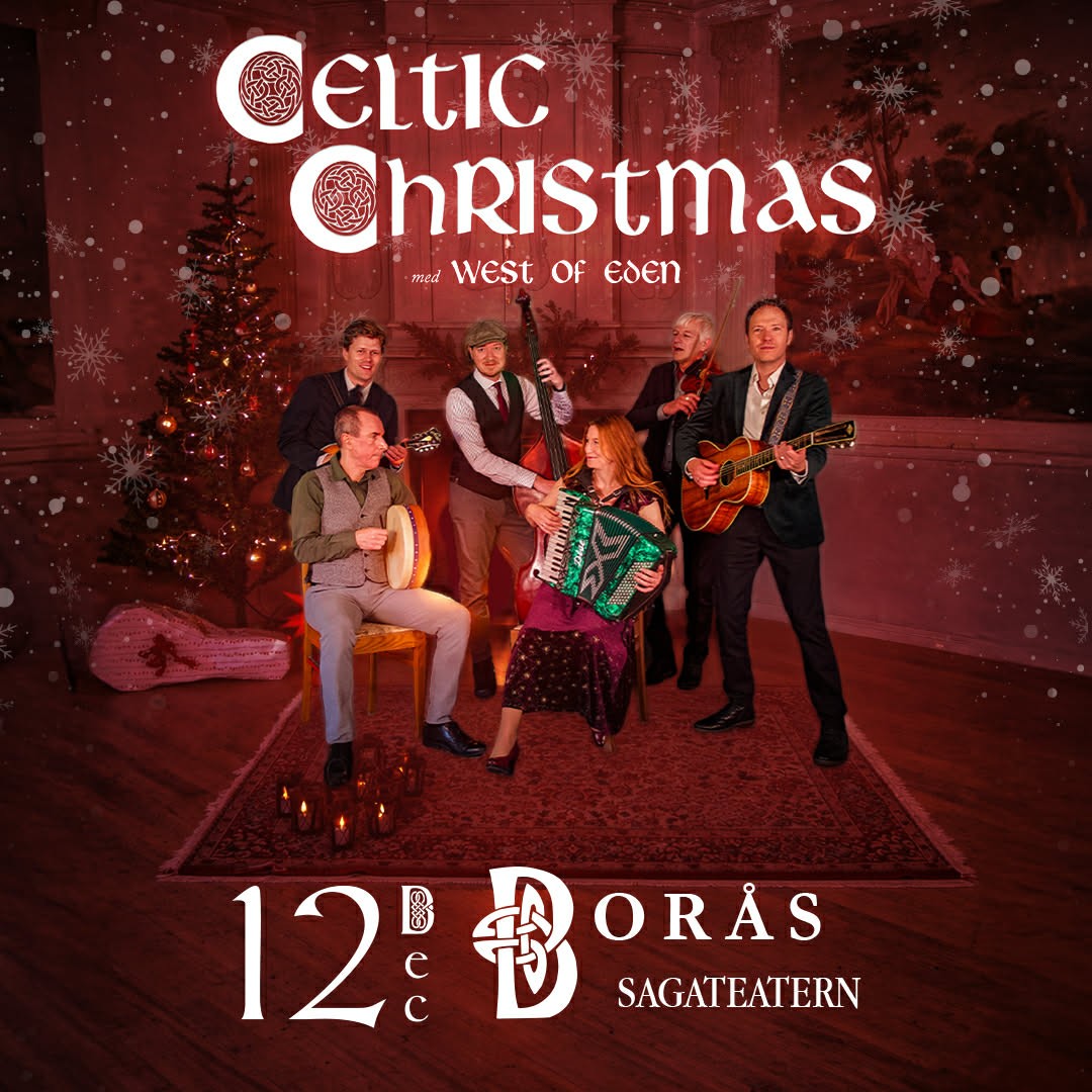 A young person with curly hair smiles at the camera while sitting in front of a laptop against a dark background.