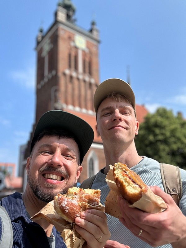Matt Slow and Pavel Rat in Gdańsk, eating local pączki donuts