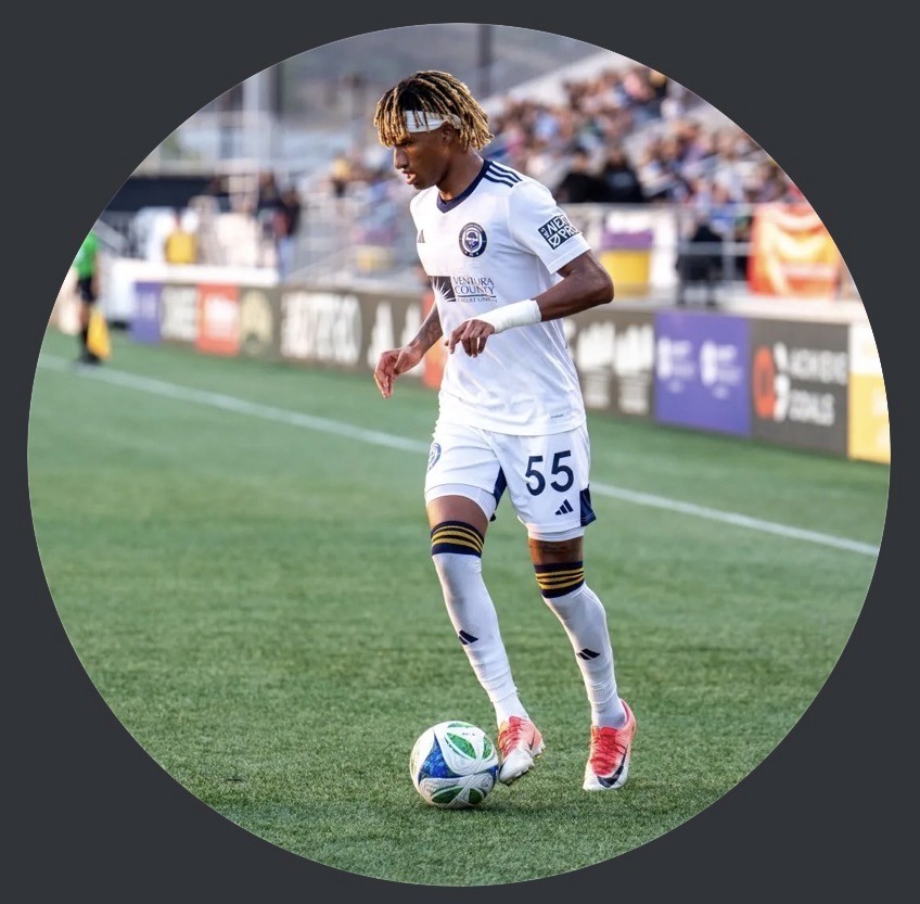 Silhouetted profile of a person in a turtleneck against a teal background. Soft lighting creates a dramatic and contemplative mood.