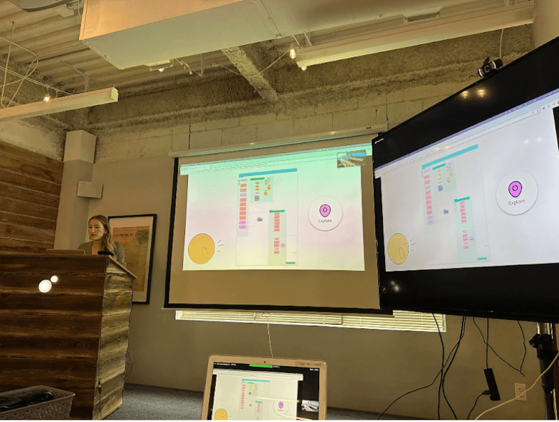 Avery standing at a podium, presenting the Soli project pitch to an audience at Viget