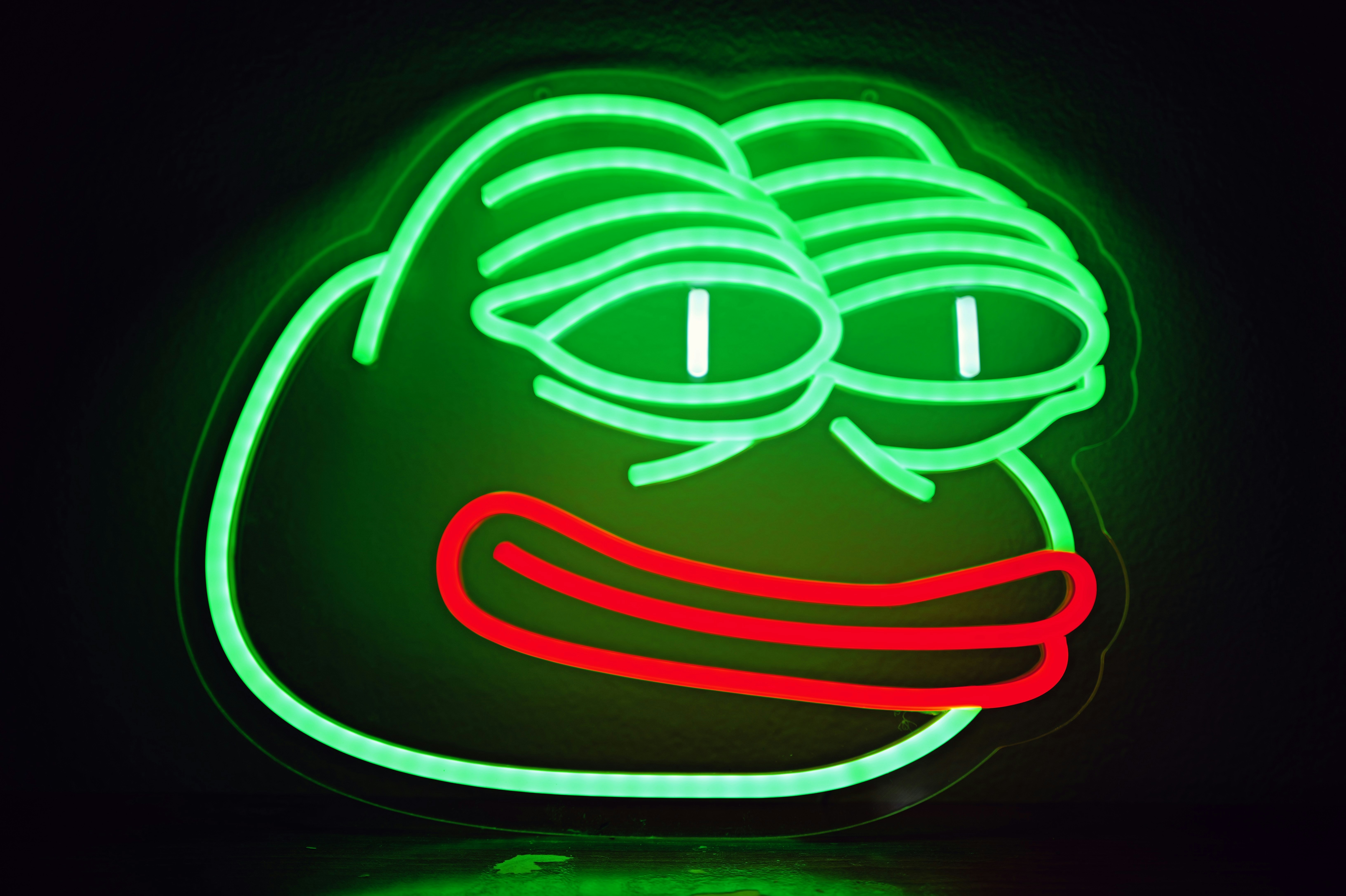 A neon green pepe the frog sign.