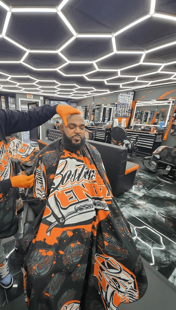 Barber cutting persons hair