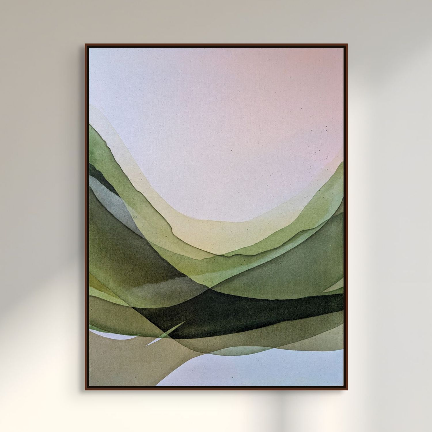 Framed abstract artwork featuring soft green and pastel waves on a light background, hanging on a wall.