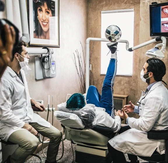Two dentists treating a patient in a Bensonhurst Dental treatment room