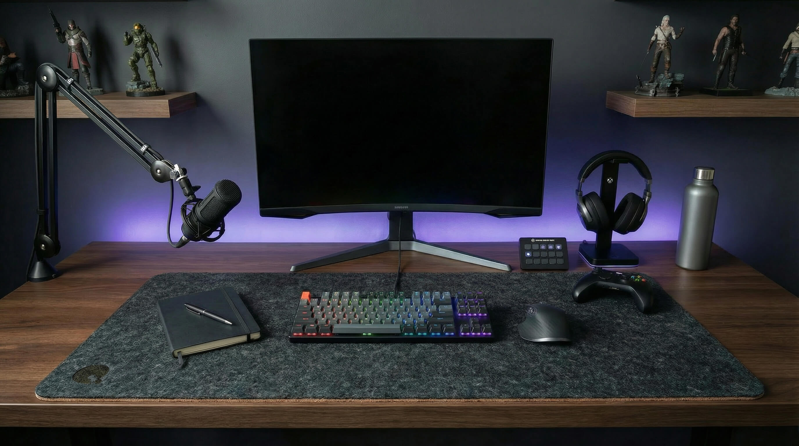 Dark grey felt desk mat in a modern desk setup with RGB keyboard