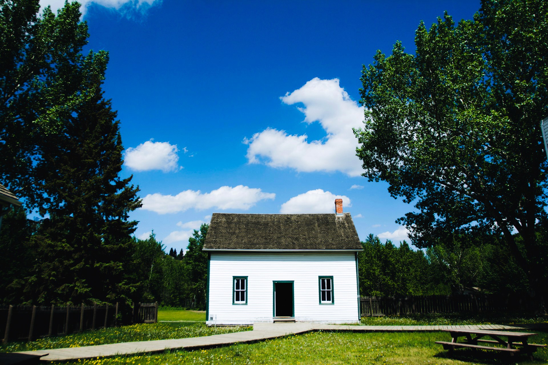 Small white house on blue sky