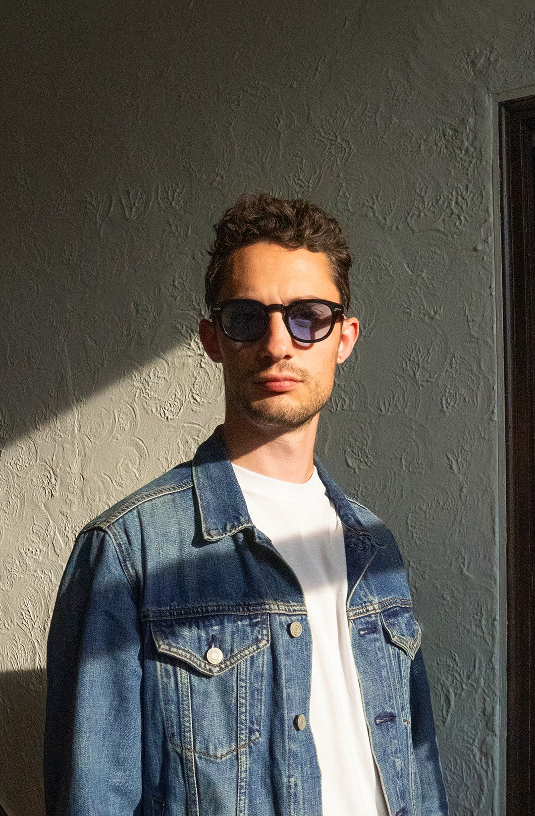 Artist Scott Schaible posing dramatically with sunlight creating a moody composition