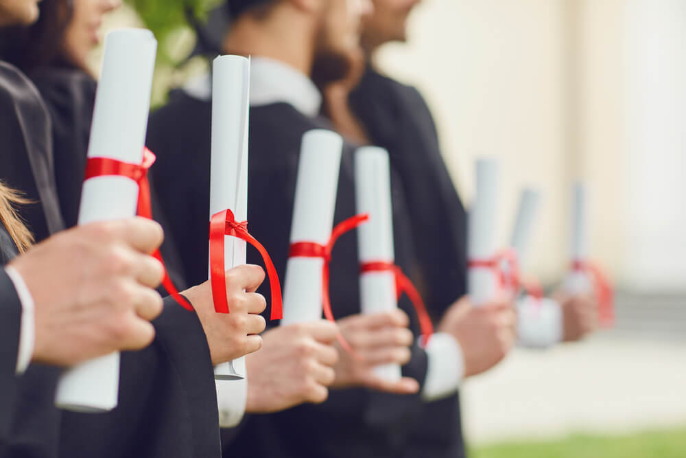 People holding degrees in hand