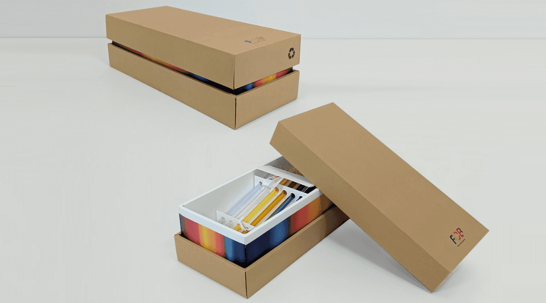 two kraft boxes next to each other on a white table, one is open and one is closed.