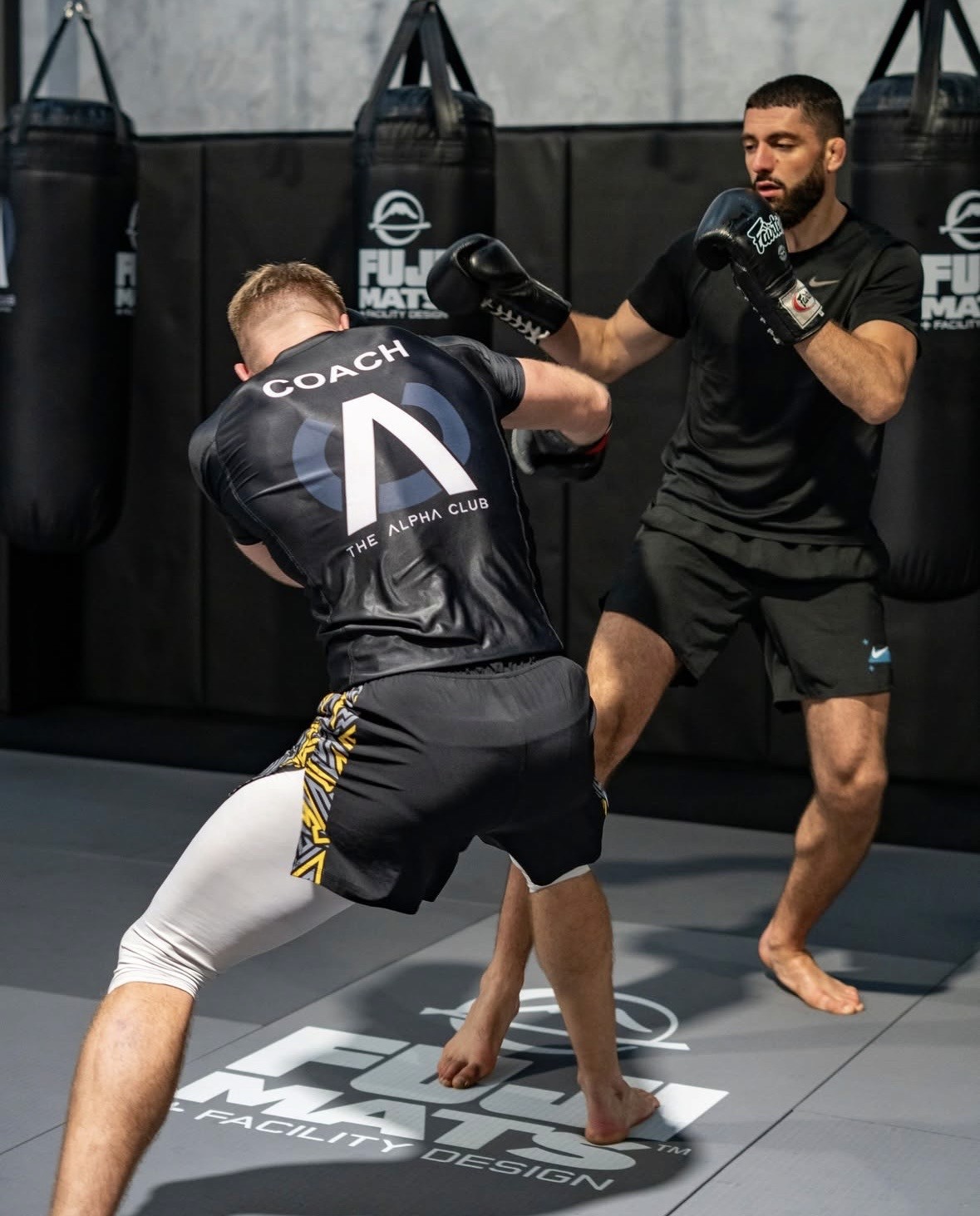 Photo of Evo X founder Deri Morgan seated outdoors at sunset with ocean view in the background