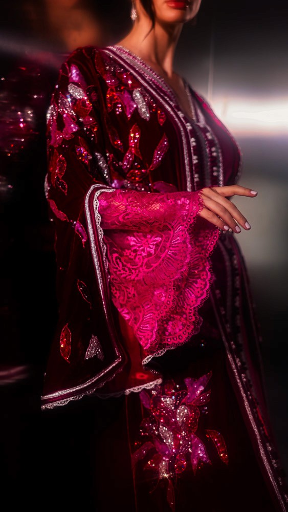 Fuchsia Moroccan caftan with sculptural sleeves and intricate embroidery, bold handcrafted couture piece in Bahrain