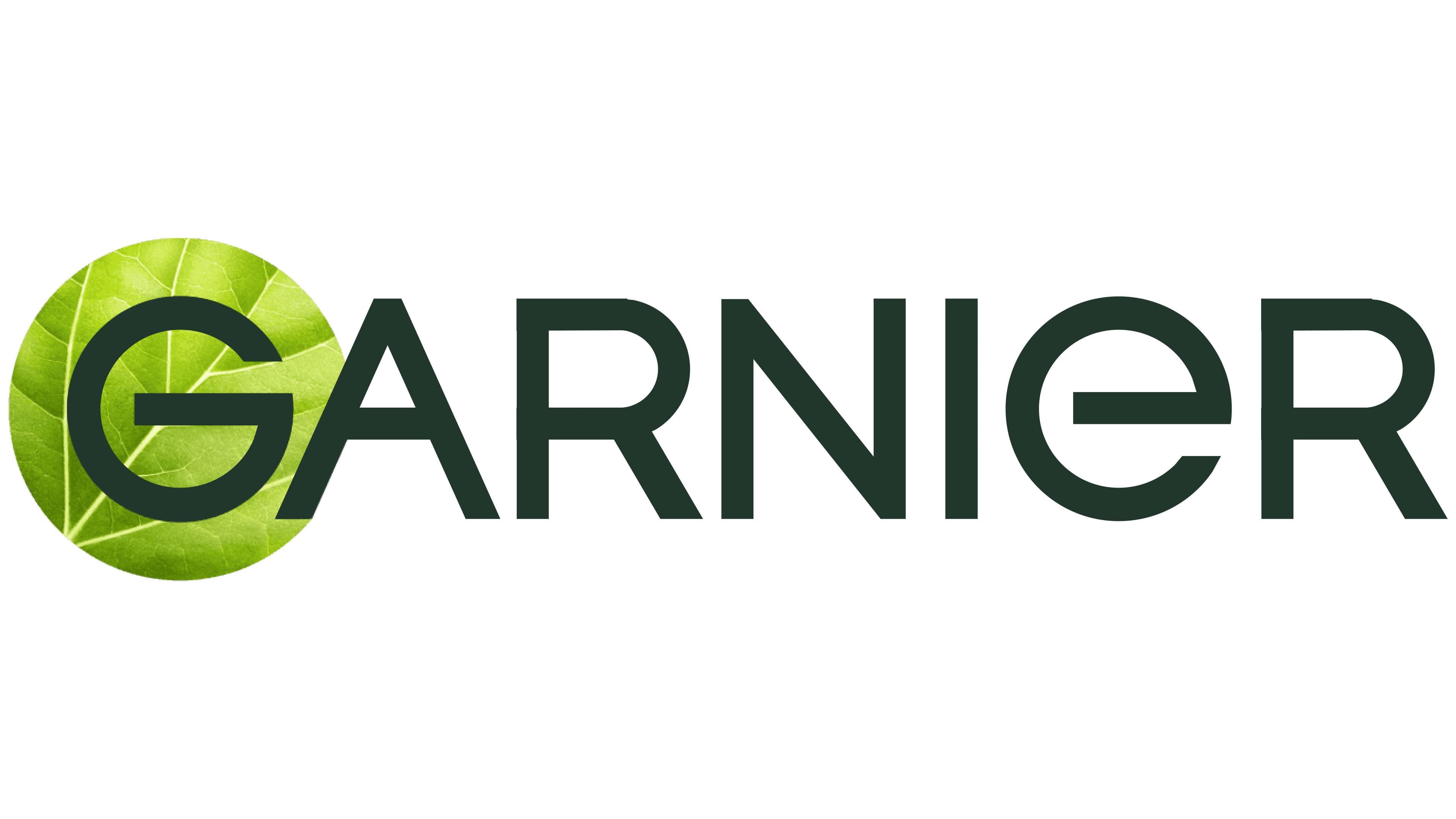 A person with short, curly blond hair wears a bright orange turtleneck sweater. The background is plain, creating a calm and focused portrait look.