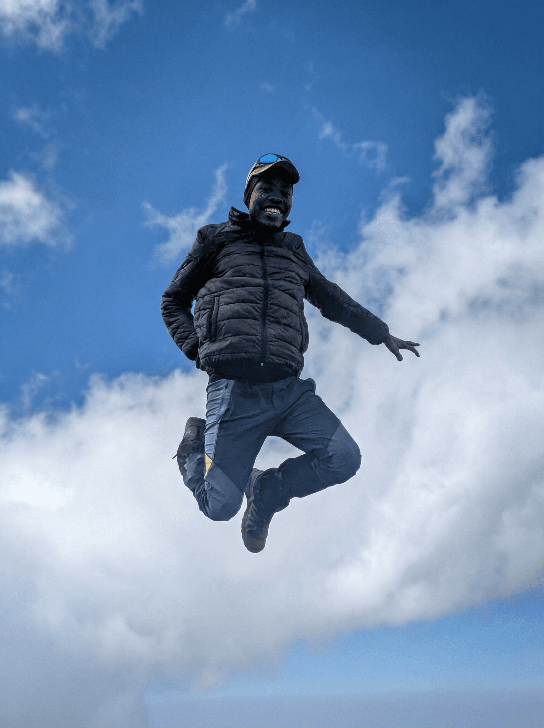 Lone traveler walking across golden dunes in AlUla desert, leaving footprints under clear morning light.