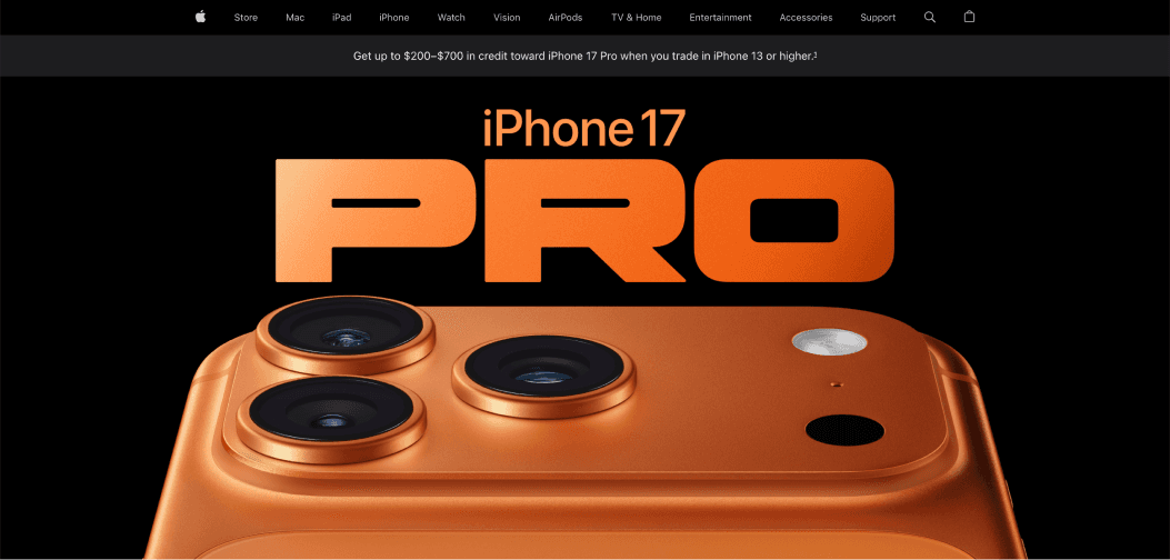 Apple iPhone 17 Pro in orange titanium finish with triple-lens camera system, displayed on a black background with bold orange “PRO” typography above.