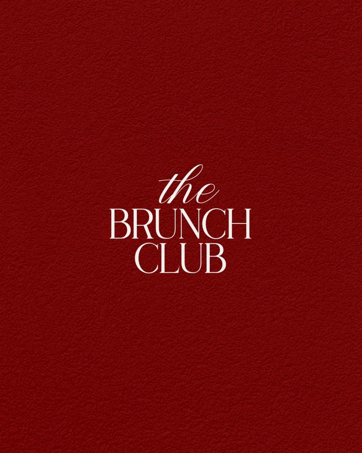 A young man with light brown hair is wearing a black suit jacket and white shirt, standing in a softly lit office setting, conveying professionalism.