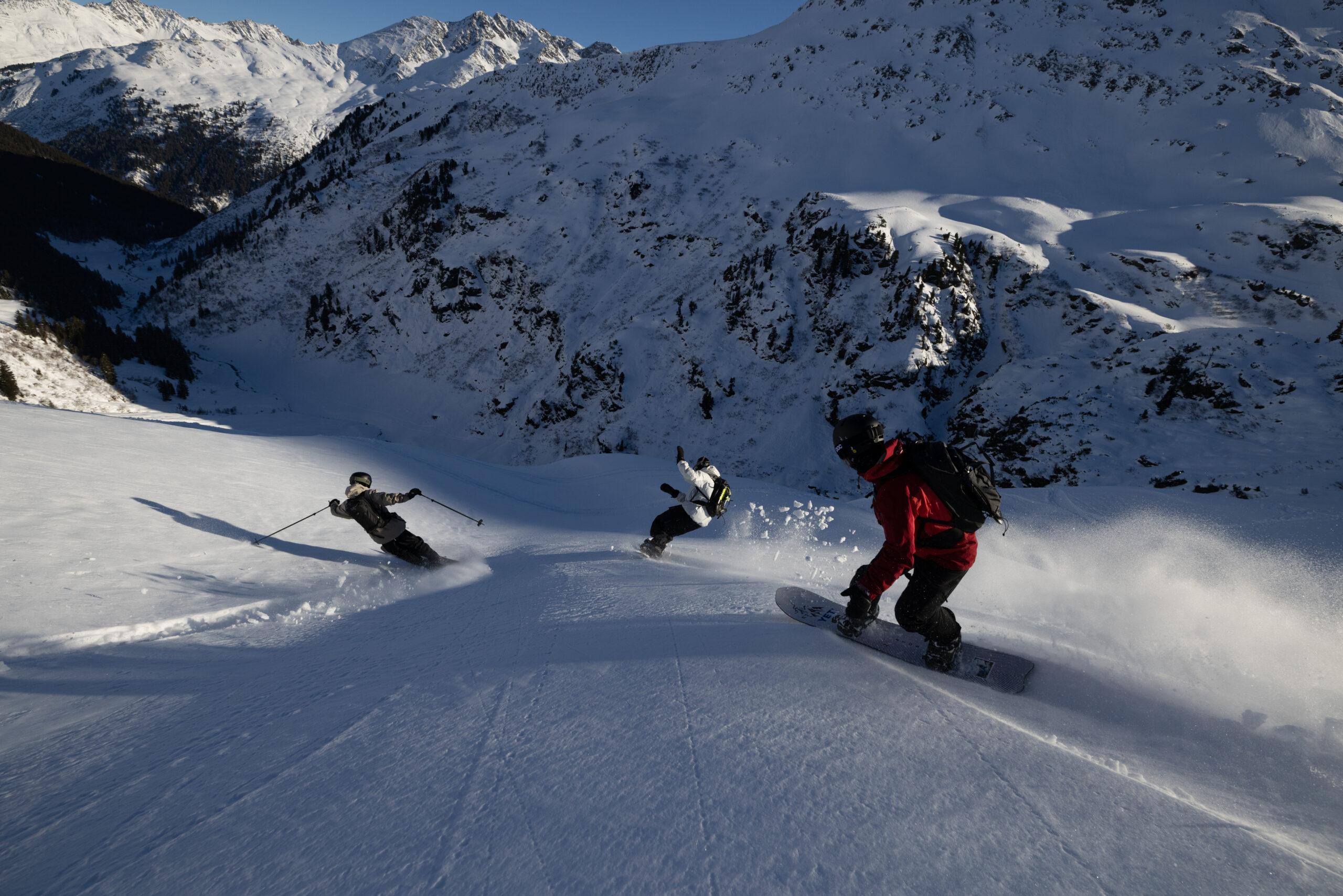 Freeride skier skiing down powder mountain
