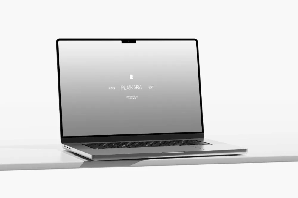 Minimalistic laptop mockup placed on a clean white surface, featuring a reflective screen with a silver body. The crisp and modern design highlights a professional aesthetic.