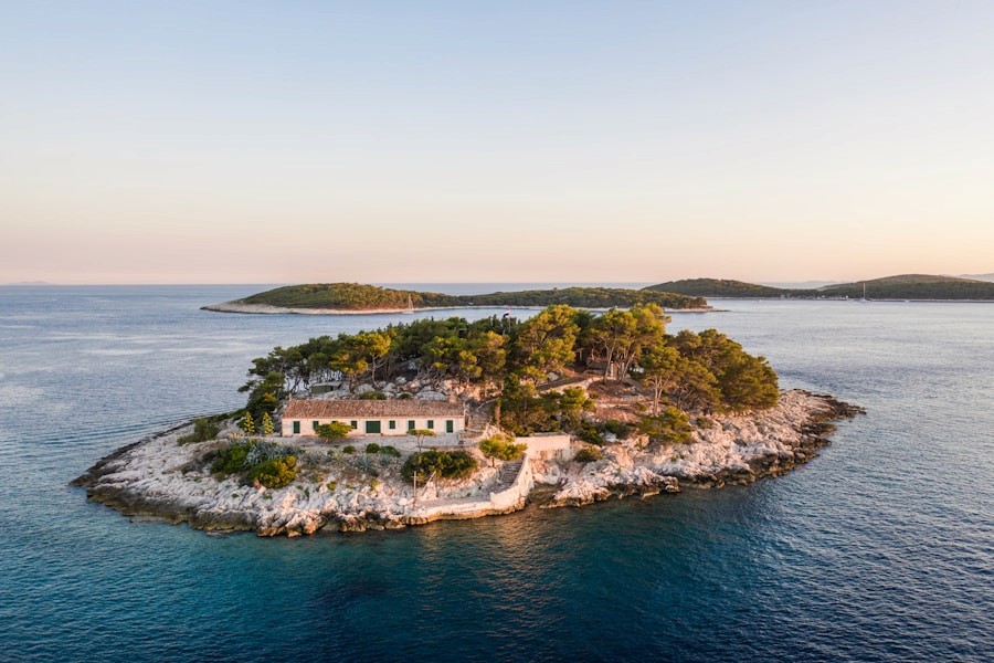 Small Croatian island surrounded by blue Adriatic water at sunset
