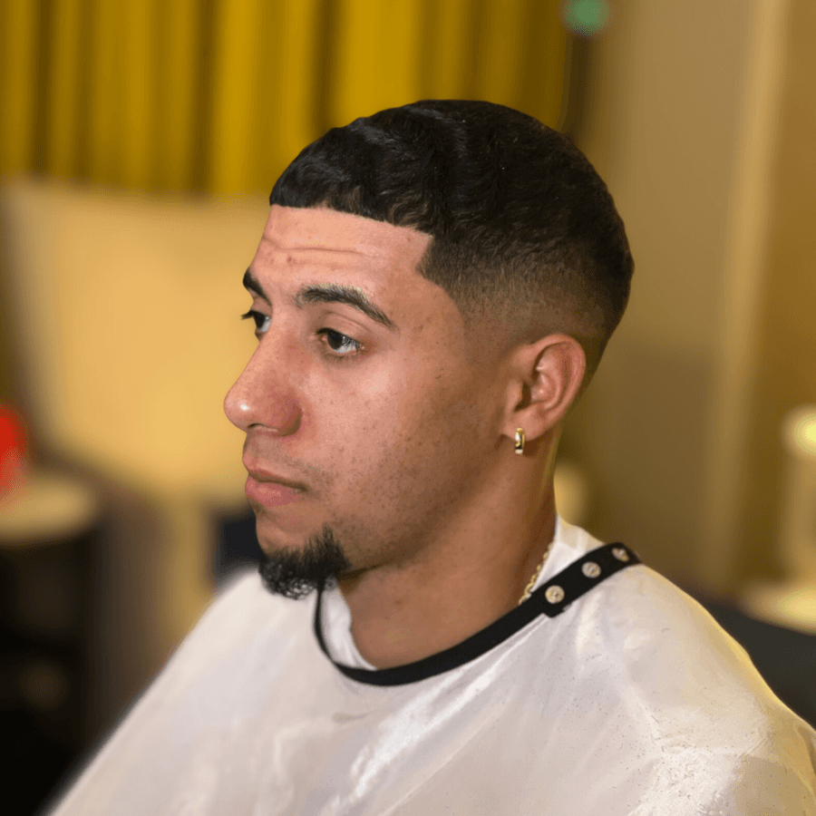 person holding white and gold hair comb