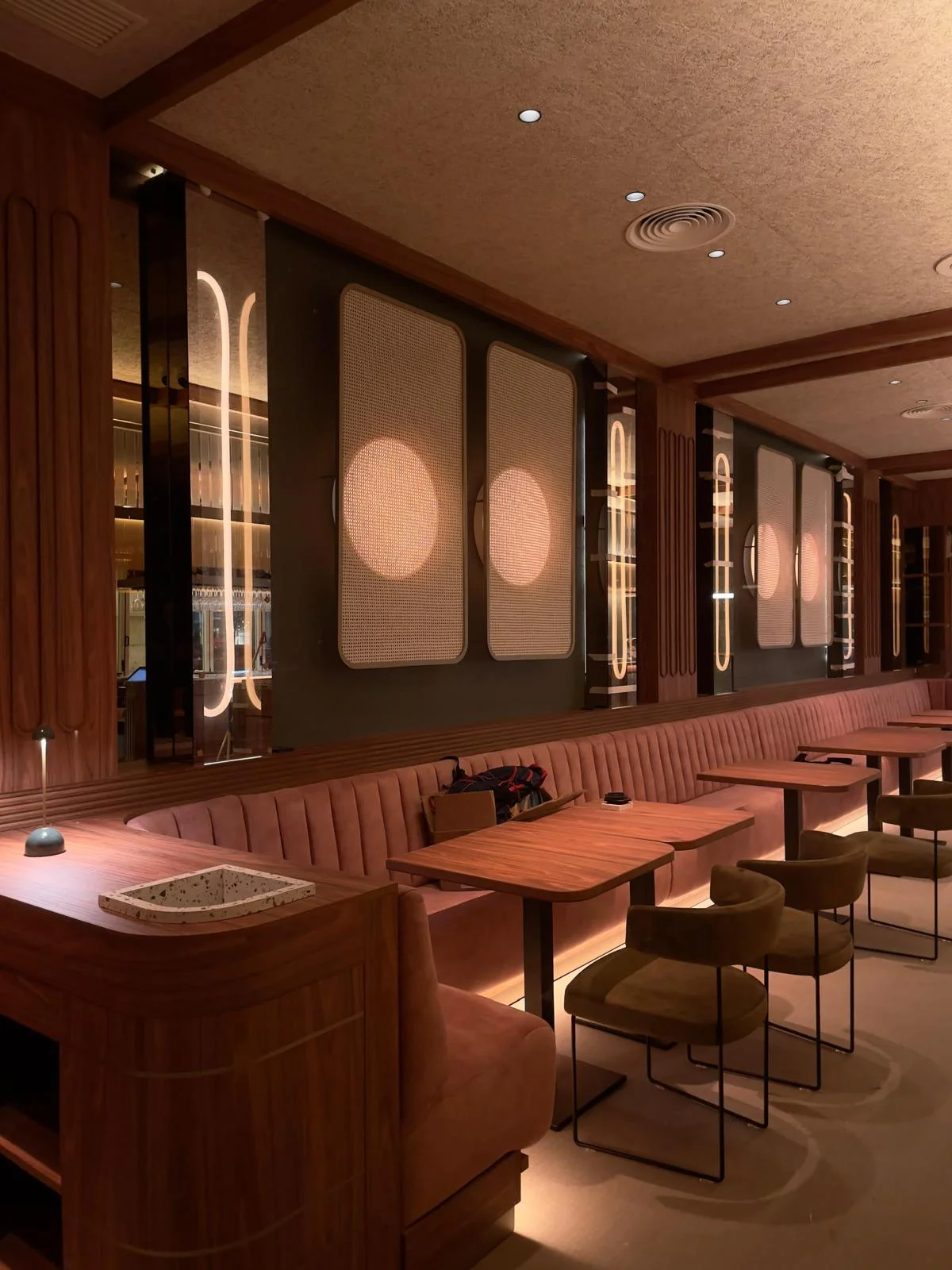 Golden cross atop a domed building with blue sky.