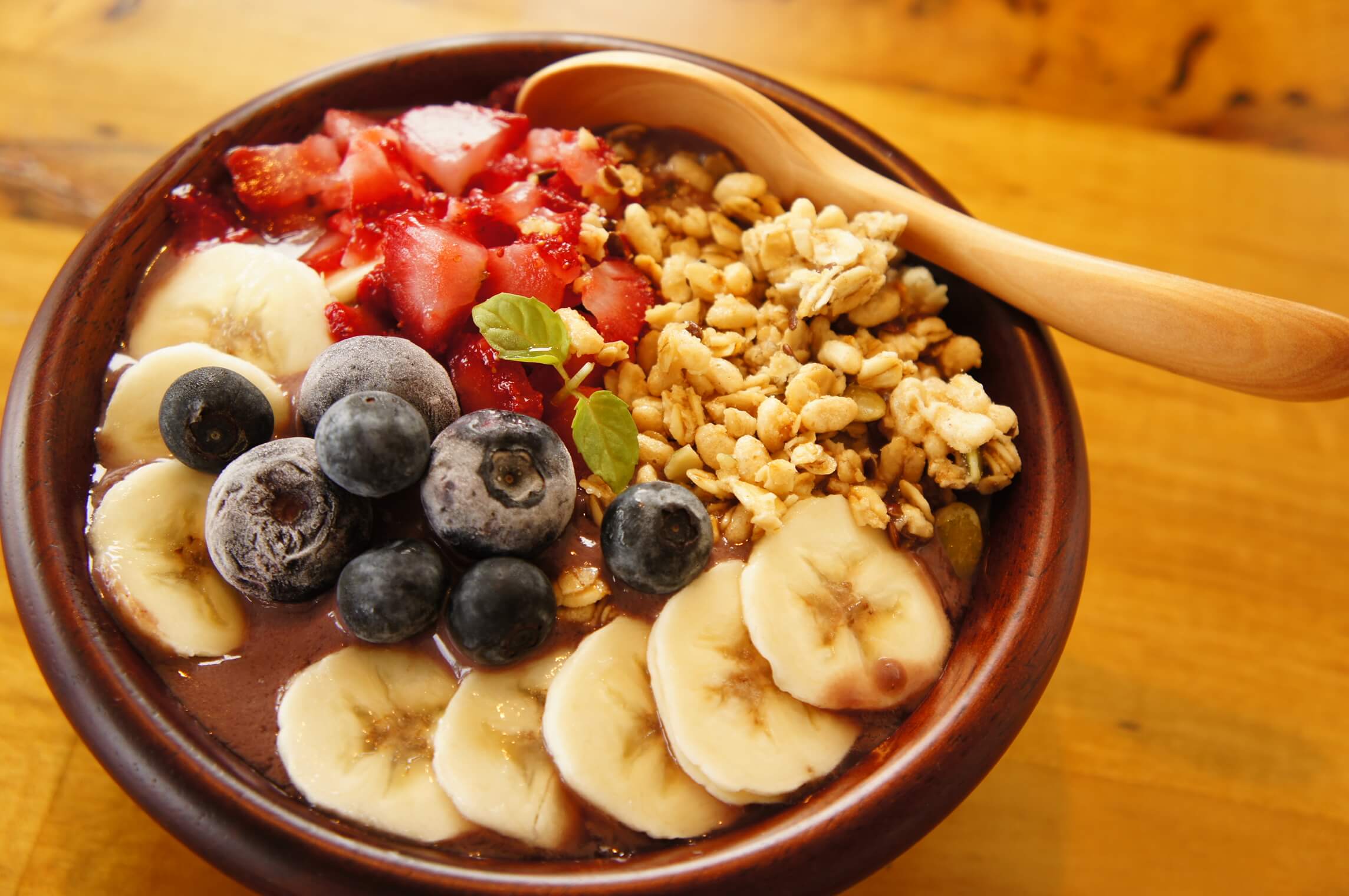 brown wooden spoon on white ceramic bowl