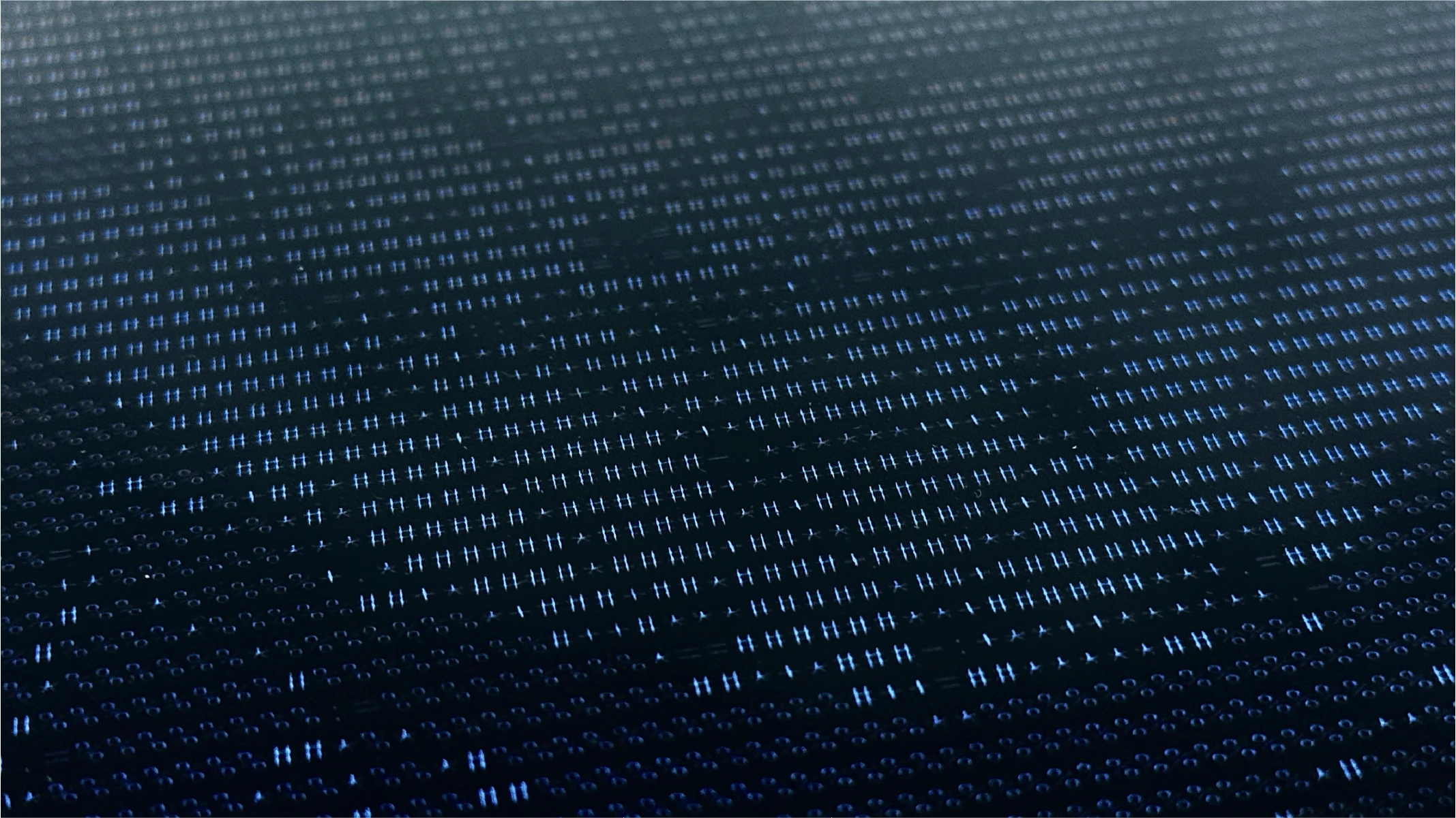 Close-up of the text with the light shining though.
