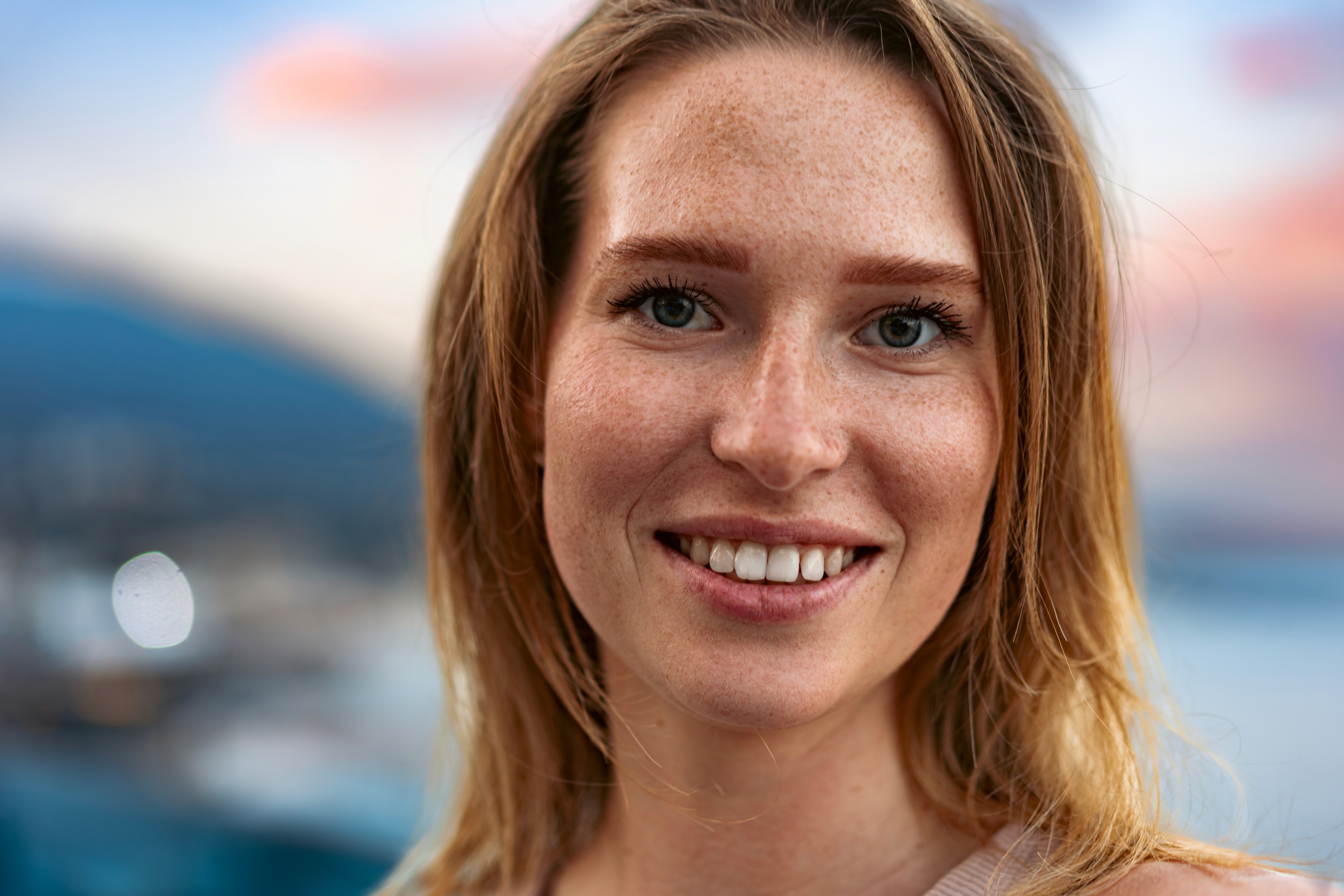 Dramatic Two-Toned Portrait of a Young Man The image is a striking portrait of a young man with a two-toned lighting effect, where one half of his face is bathed in cool blue light.