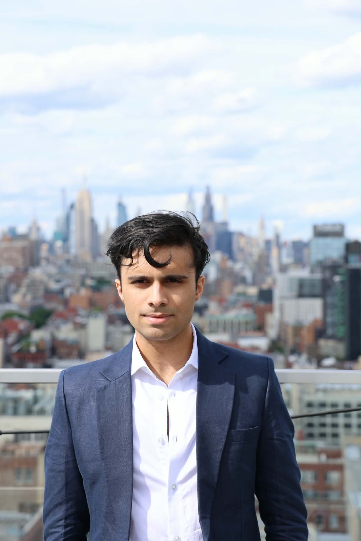 a man standing in front of a purple wall