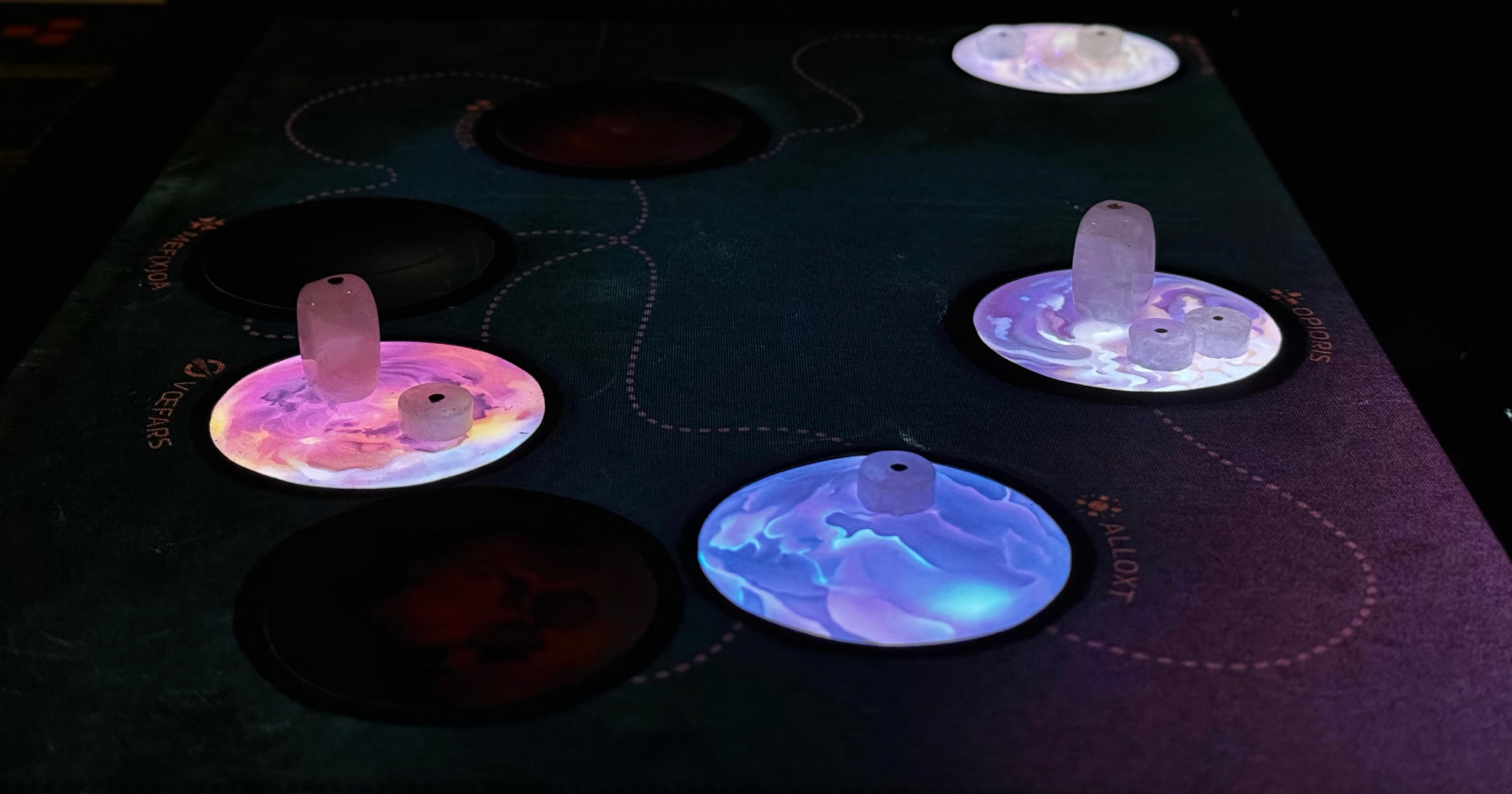 Light-up game board with player "crystal" power stations.
