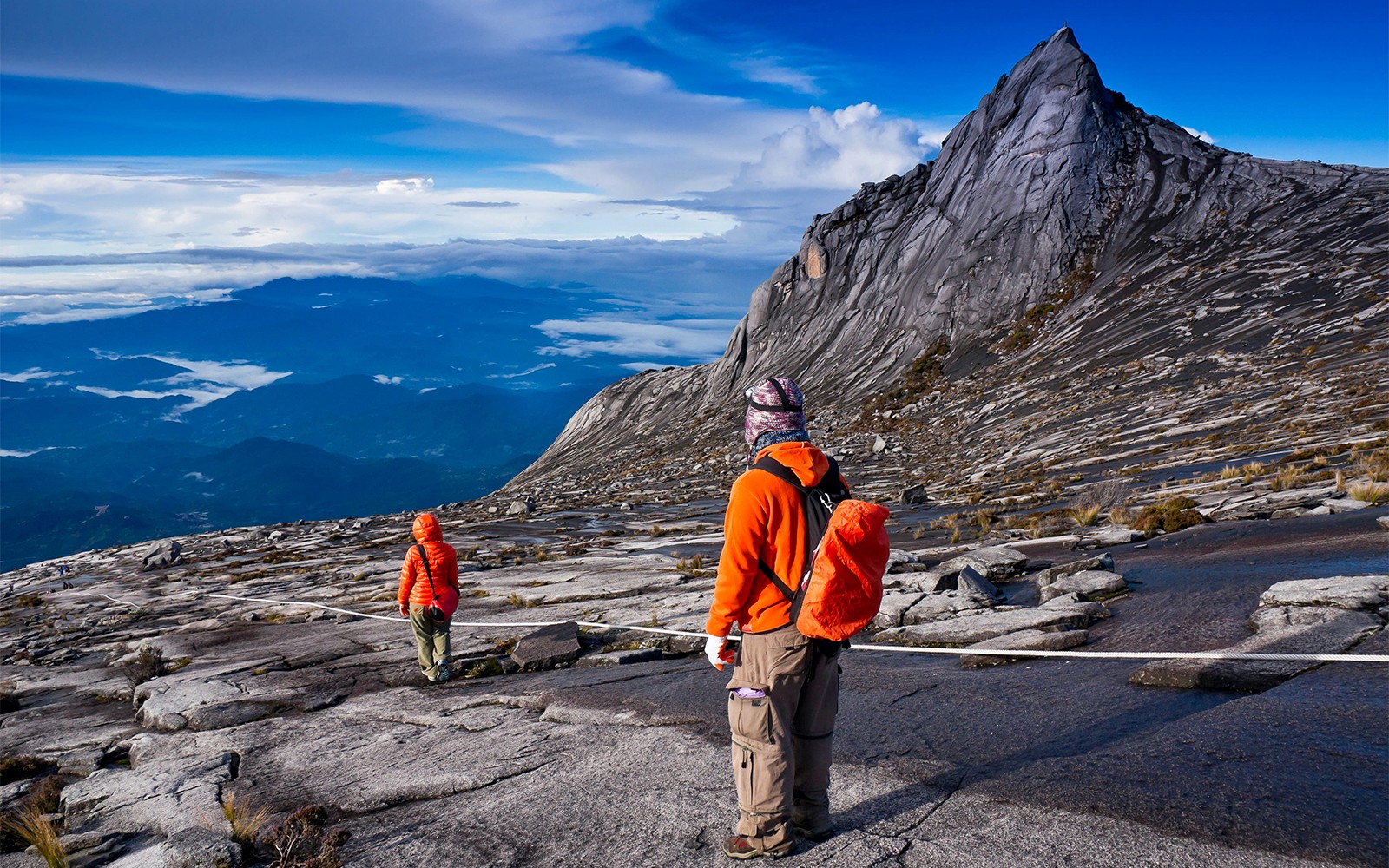 Hikers ascending rocky path on Mount Kinabalu Summit Tour, Malaysia.
