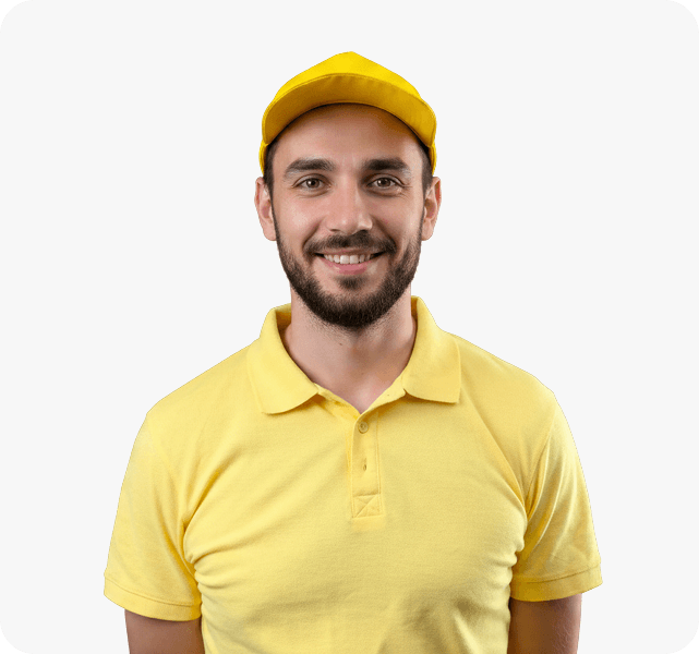 Lead Moving Specialist Jhon Namco smiling in a yellow uniform shirt and cap.