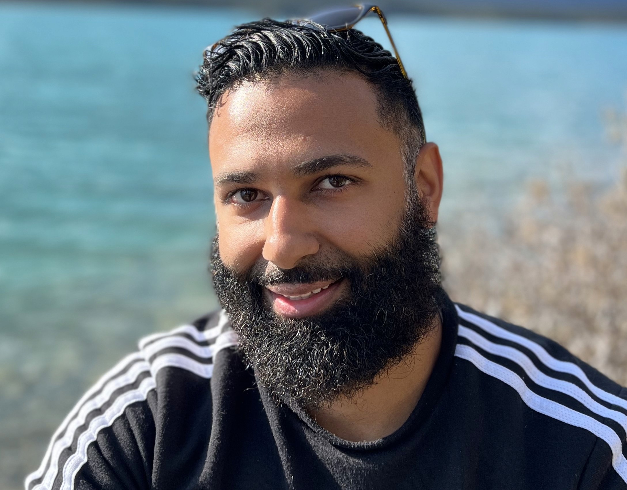 Portrait of a person in a pink sweater against a light background