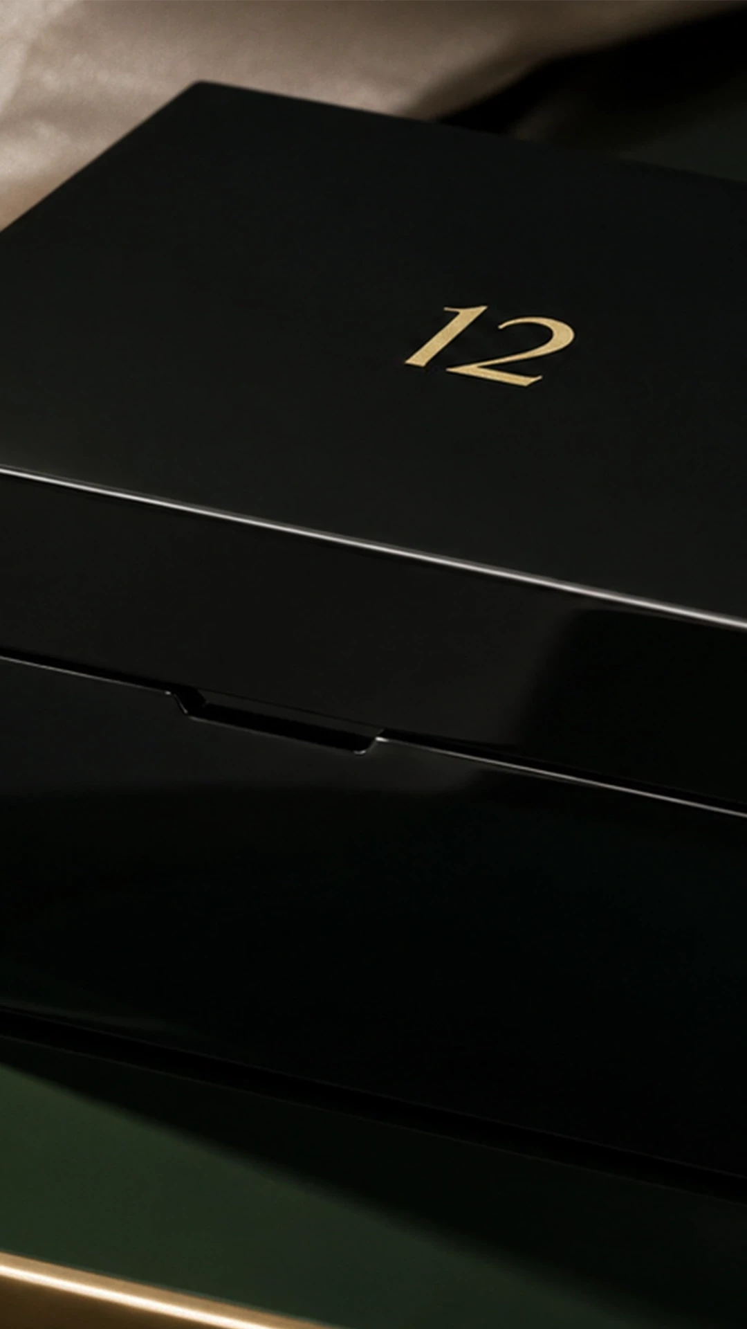 A luxury bespoke, high-gloss black lacquered luxury jewellery box with gold numbering at a master artisan workshop.A luxury bespoke, high-gloss black lacquered luxury jewellery box with gold numbering at a master artisan workshop.