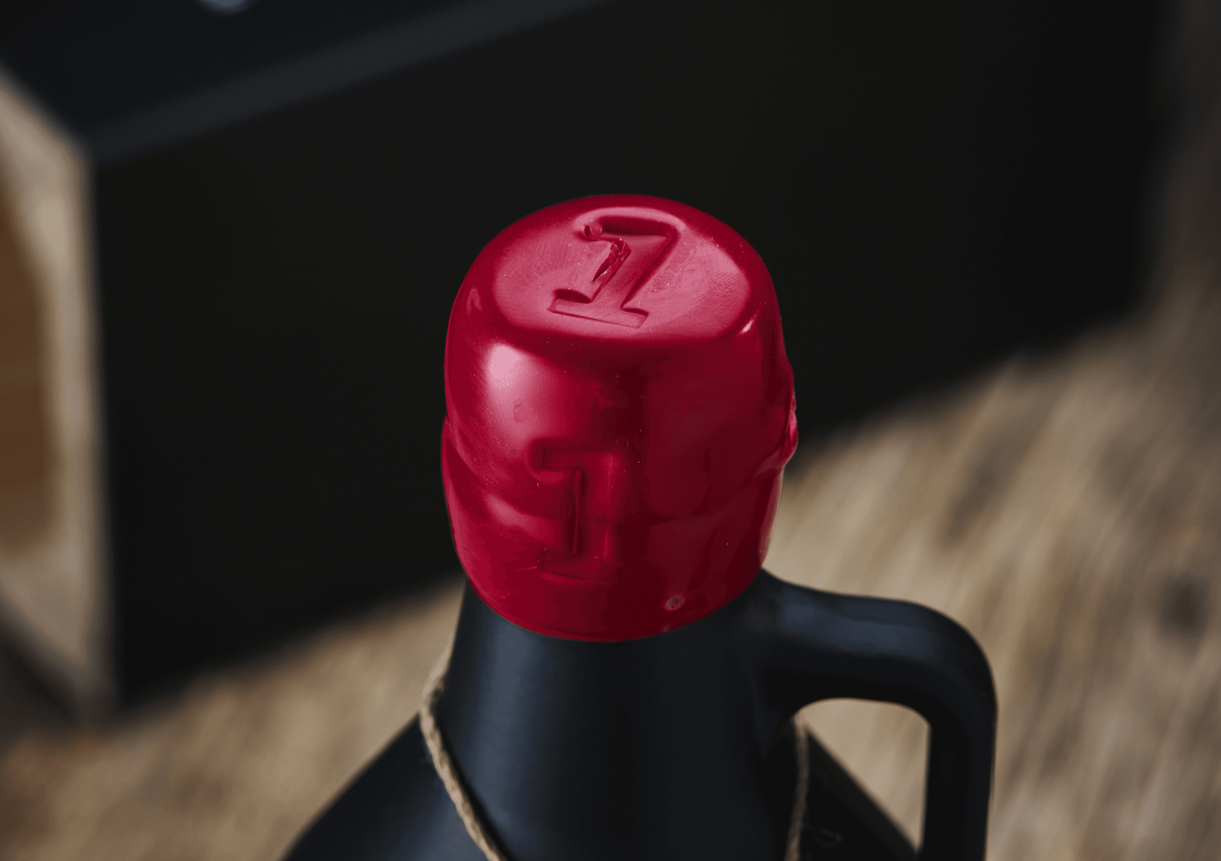 Red wax seal on bottle cap with embossed number 7
