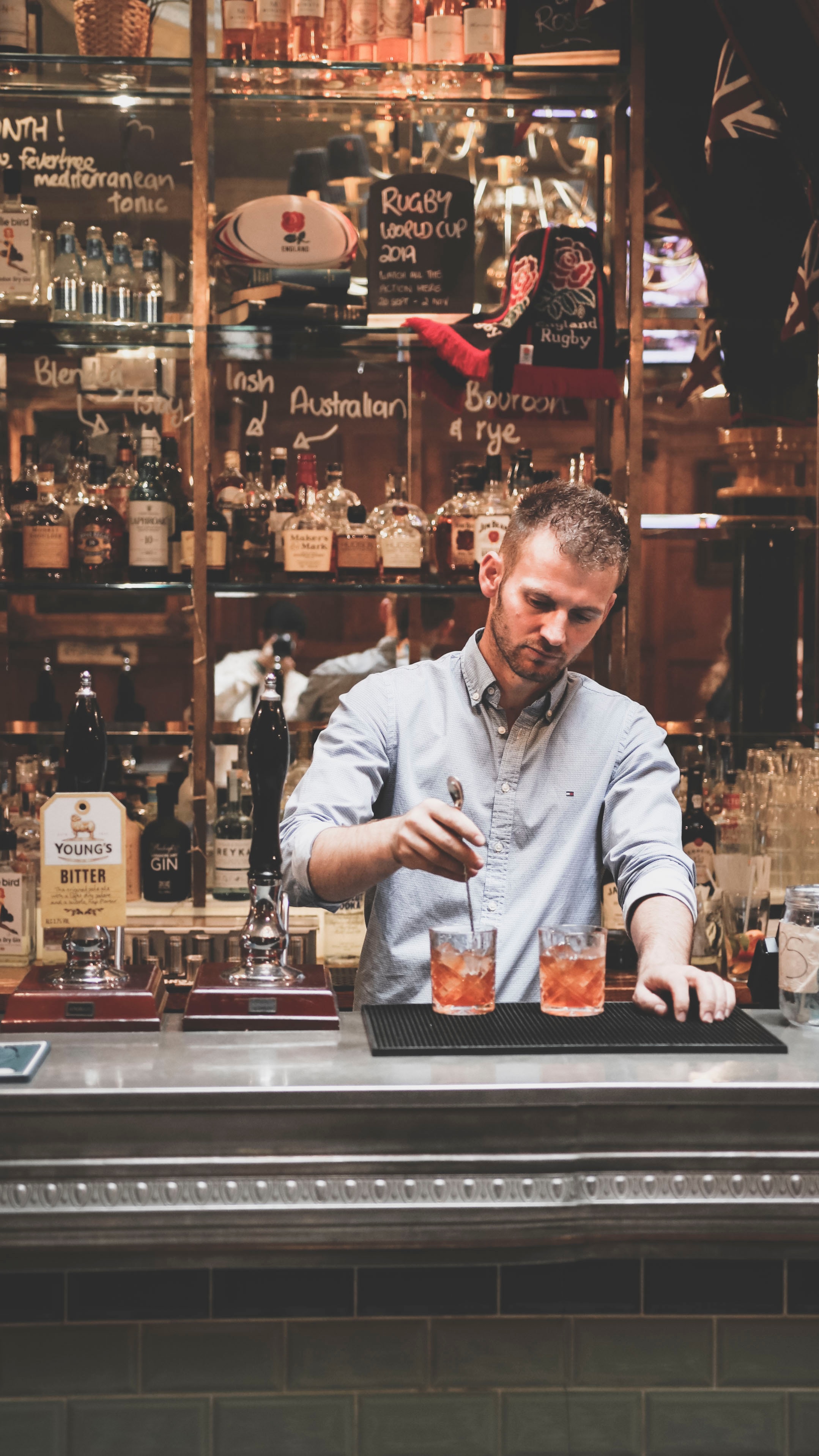 bartender mixing drinks at bar