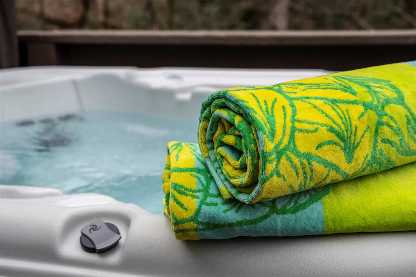 Rolled beach towels on the edge of the Bella Vista hot tub
