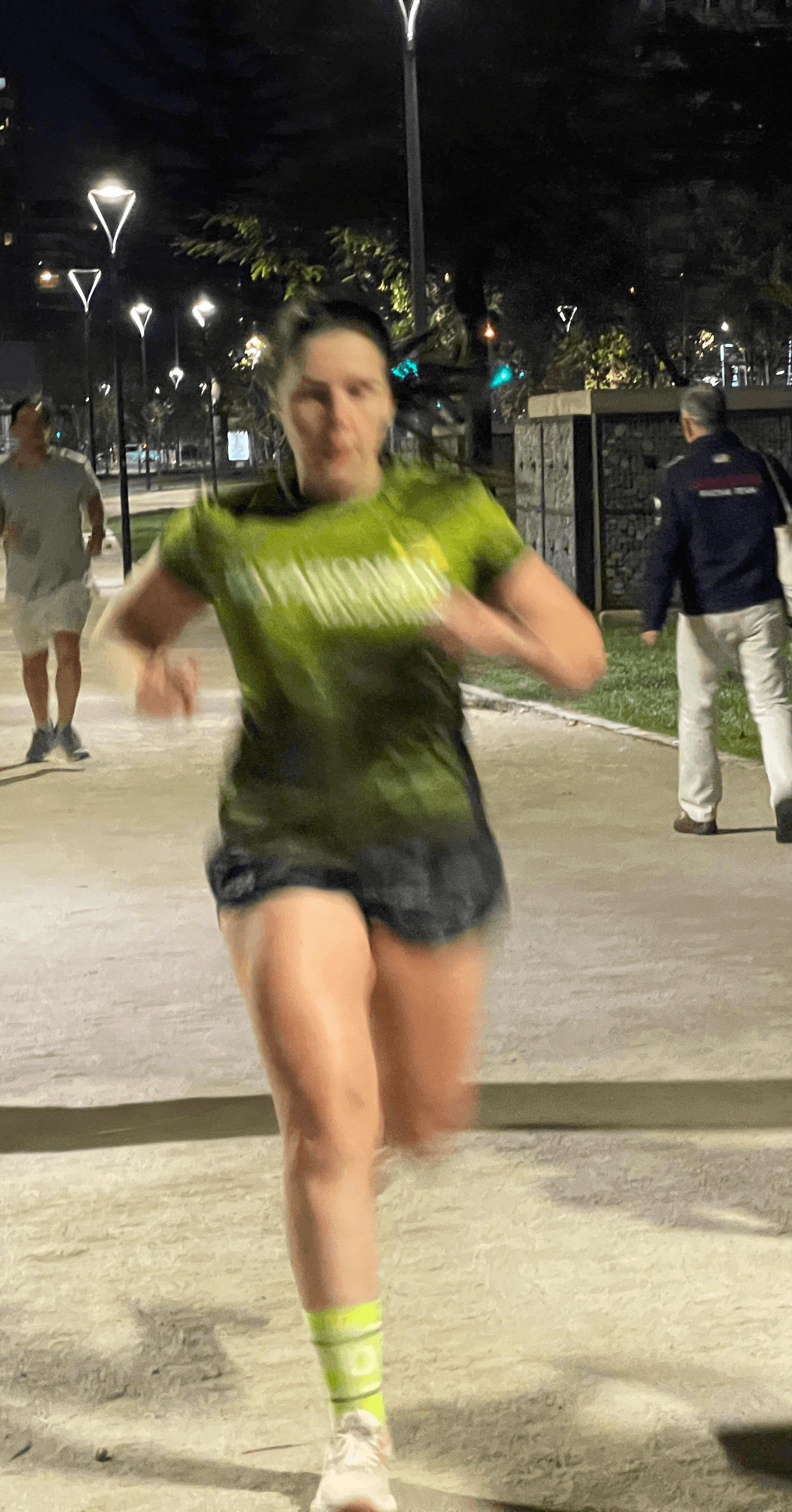 Portrait of a person in a pink sweater against a light background