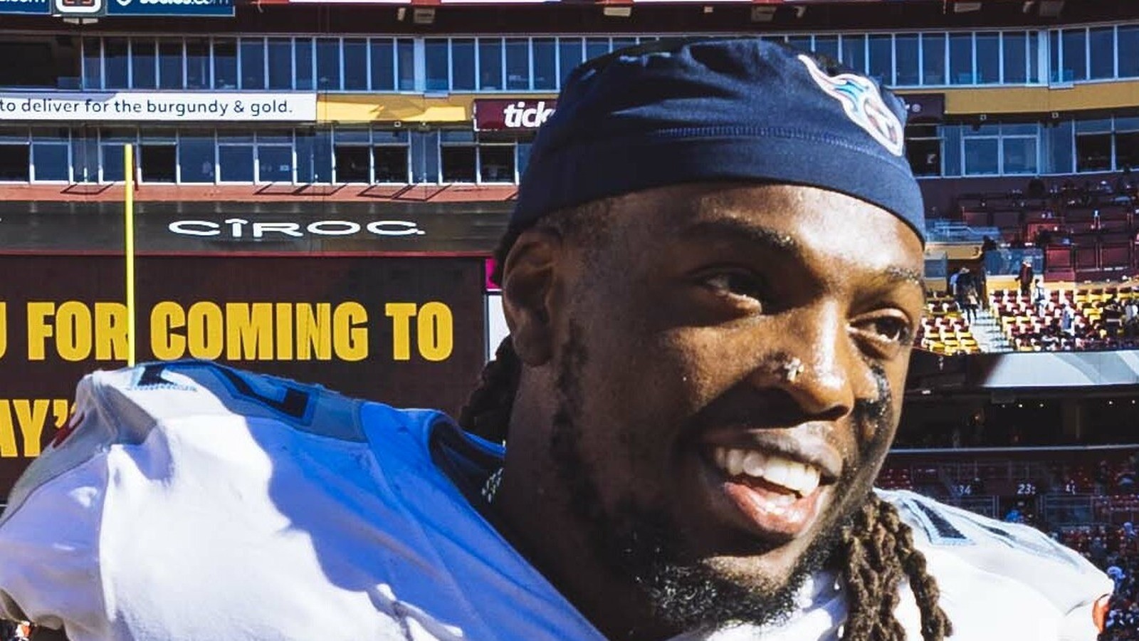 Close-up of Derrick Henry smiling in Titans gear, face centered