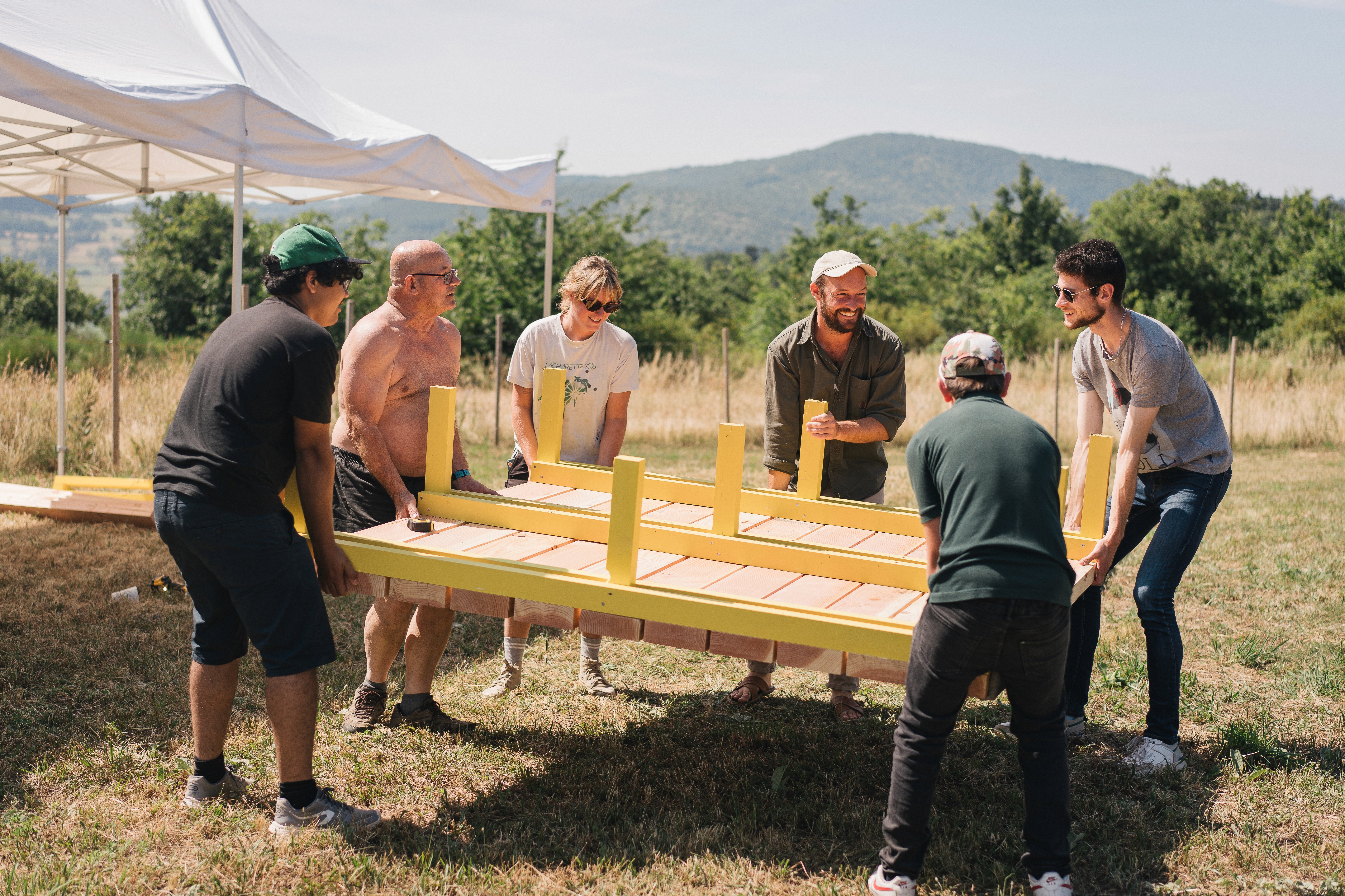 brown and white concrete house near green trees during daytime