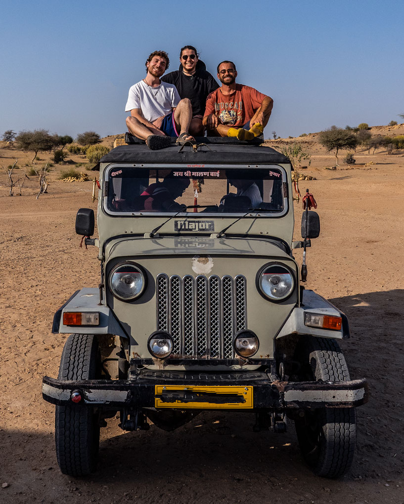 sitting on the jeep in the middle of the Rajasthan desert